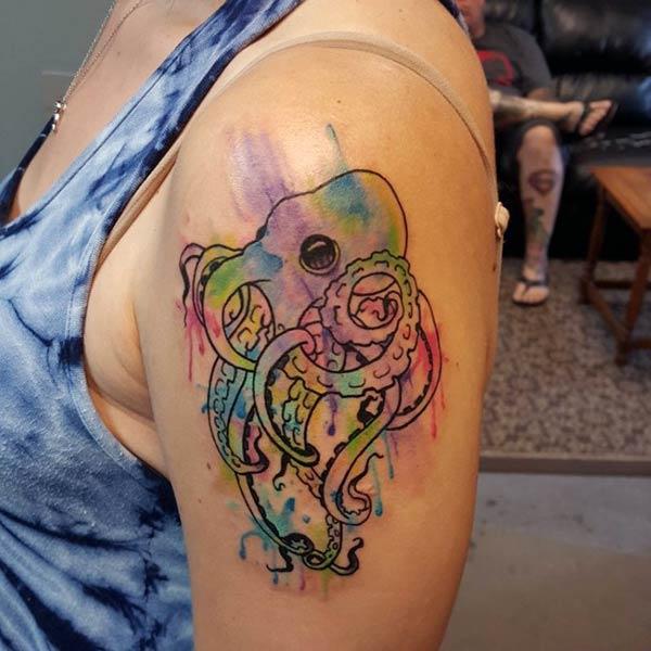 Octopus Tattoo with orange and purple ink design makes a woman look attractive