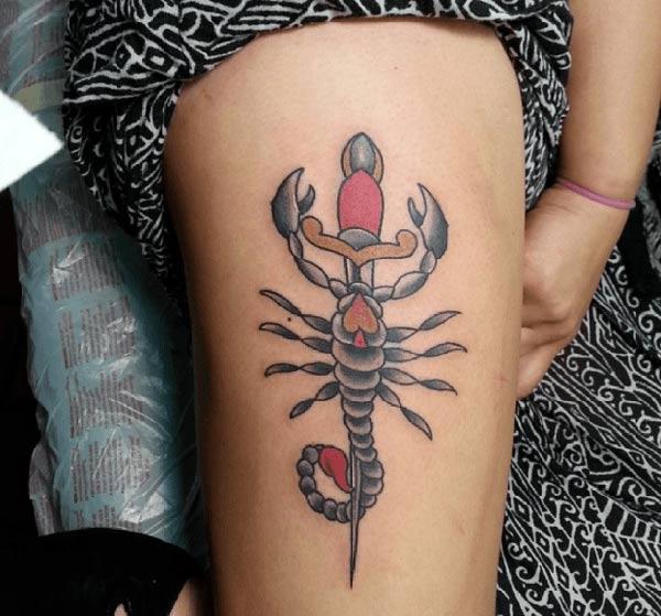 Girls makes a divine Scorpion Tattoo on thigh to flaunt it