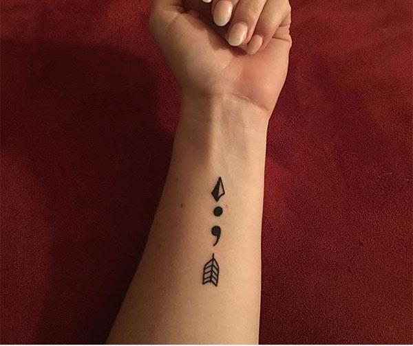The Ink design in this Semicolon tattoo matches the skin color to make a woman look magnificent