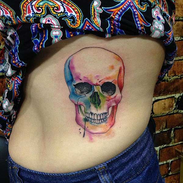 Skull Tattoo with a colorful ink design gives the captive look in girls