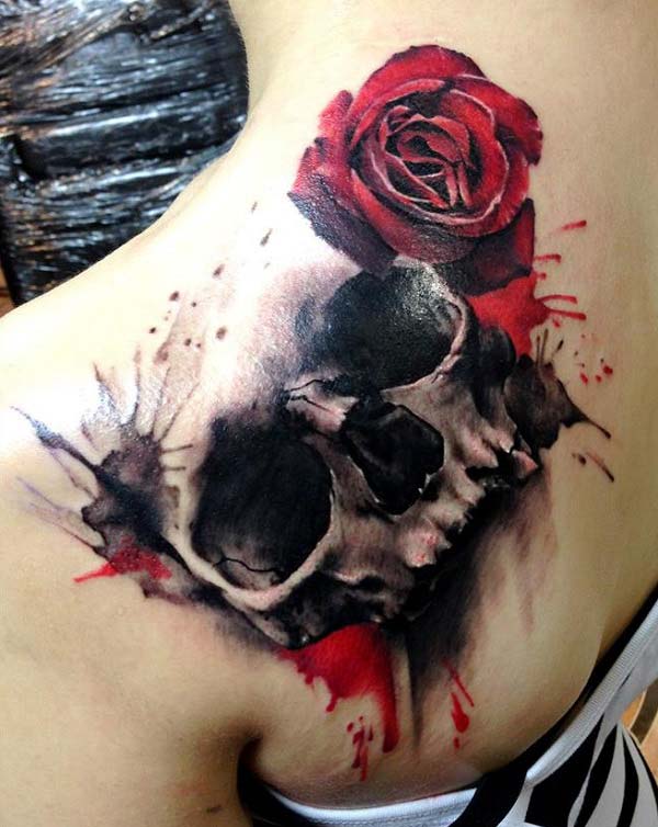 Skull Tattoo with a black and pink ink, flower design make a girl look elegant