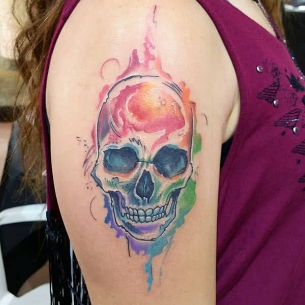 Skull Tattoo on the upper arm makes a woman look captivating