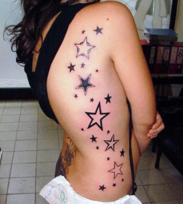 Star Tattoo with a black ink design makes a girl look attractive