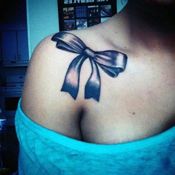 Bow tattoo for the shoulder gives the captive look in girls
