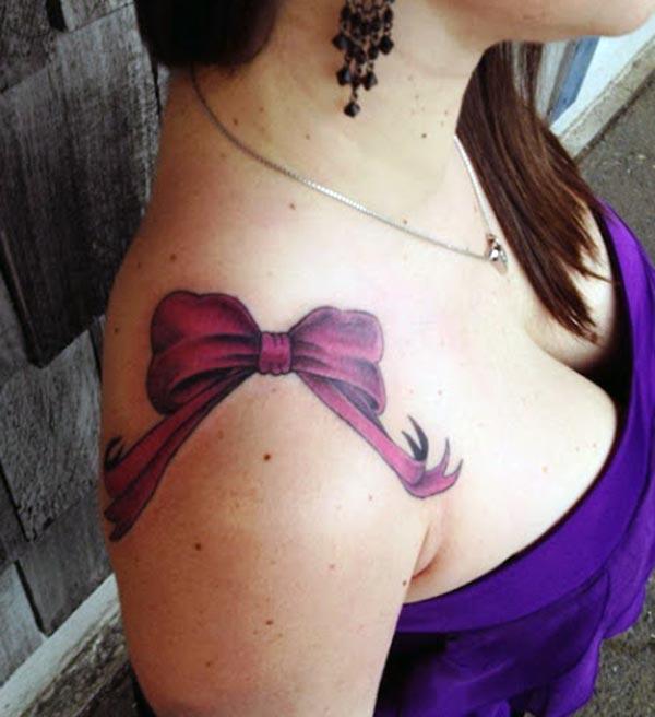 Bow tattoo on the upper shoulder make a girl attractive and elegant