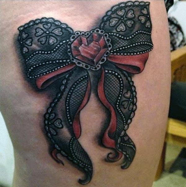 Bow tattoo for the upper thigh brings their feminist look.