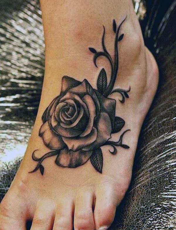 Foot Tattoo for girls with a black flower design make them look ornate