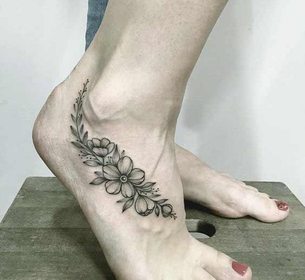 Foot tattoo on the leg makes a girl look imposing
