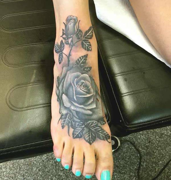 This bright foot tattoo with a flower design make girls look more charismatic