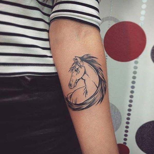 Horse tattoo on the lower arm makes a woman look attractive