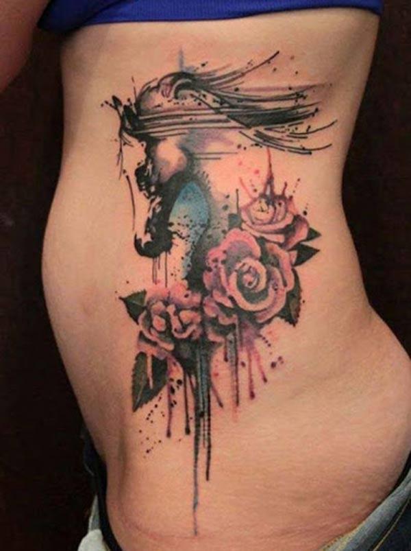 Horse tattoo on the side with a pink flower ink design brings a gorgeous look