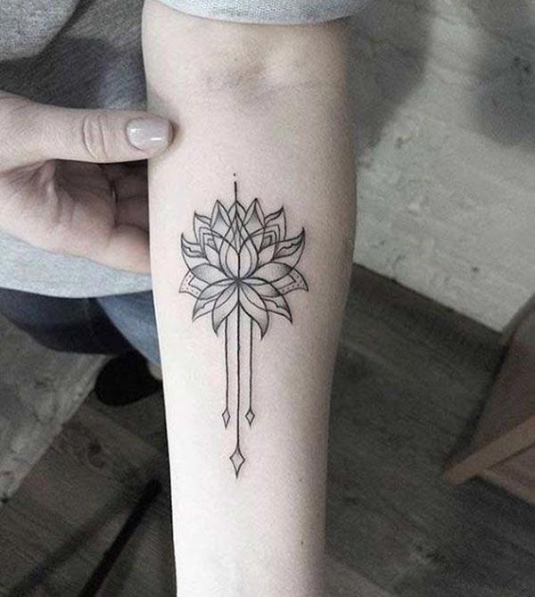 Lotus Flower tattoo on the lower arm makes a girl appear charming 