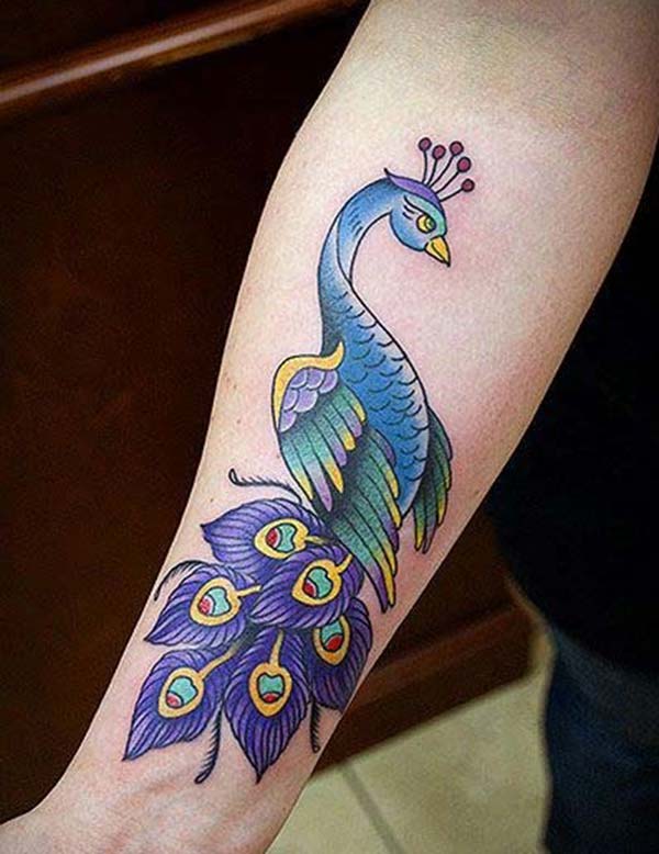 Peacock Tattoo on the lower arm makes a woman look captivating