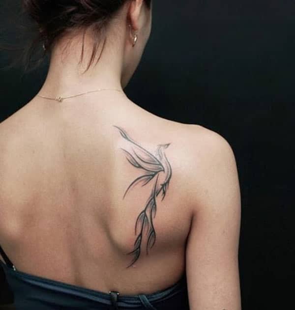 Black ink design of the Phoenix tattoo on the back of ladies make them look attractive