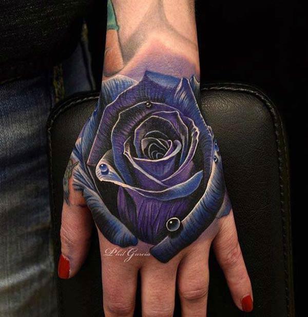 This purple ink design of the Rose tattoo on the hand to make a girl look admirable