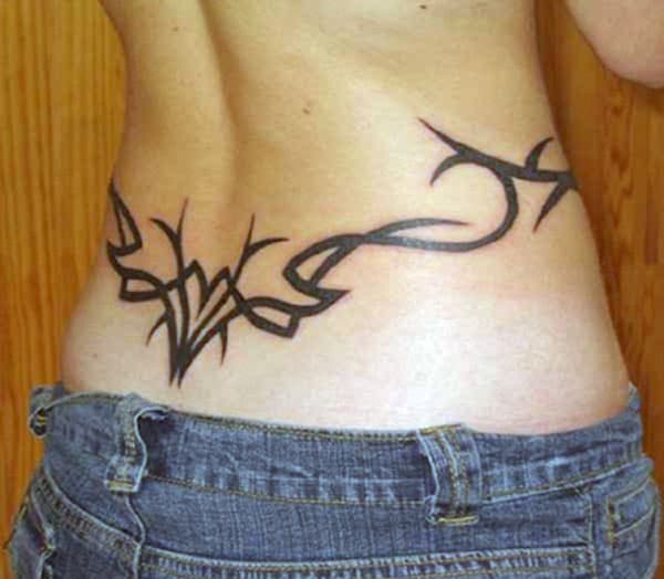 Tribal Tattoo above the hips with a black ink design brings the captivating look