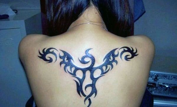 The black ink design in of the Tribal Tattoo on the back, make girls have splendid look