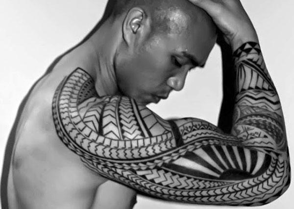 Tribal tattoo with a black ink design makes a man look elegant