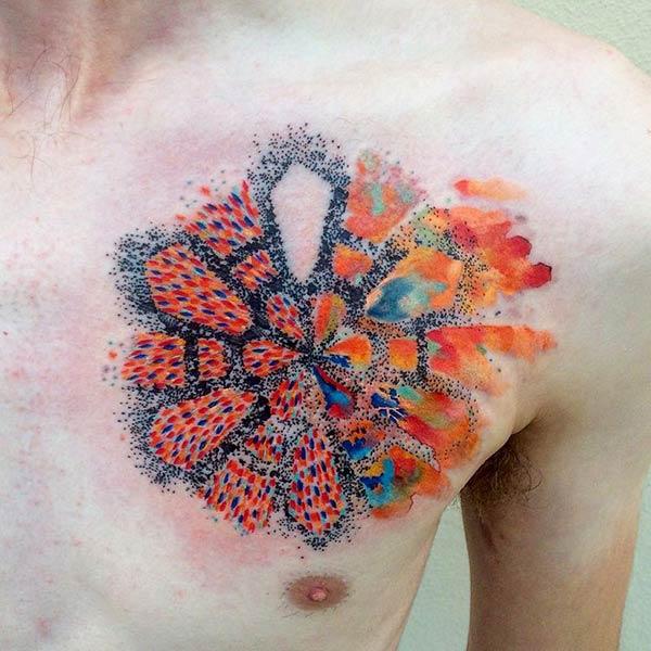 Funky and artistic speck fused water color ink chest tattoo ideas for art loving males