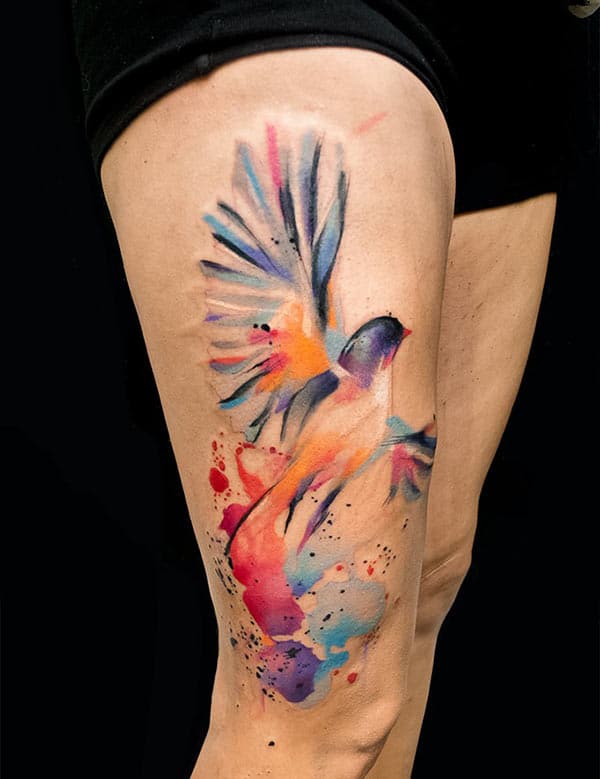 Vibrant catchy flying birds watercolor thigh tattoo ideas for Females