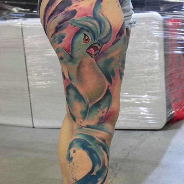Adorable watercolor tattoo of bird surfing for stylish girls on thigh