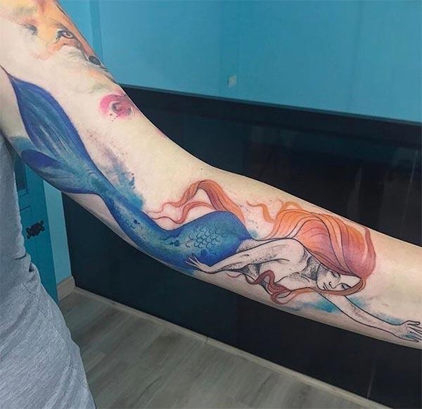 Ladies Elegant alluring swimming mermaid watercolor tattoo on arm