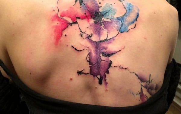 Catchy Ink explosion watercolor back tattoo for girls