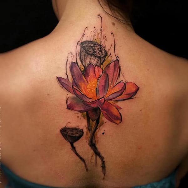 Garish flower with buds back tattoo design for fashionable girls
