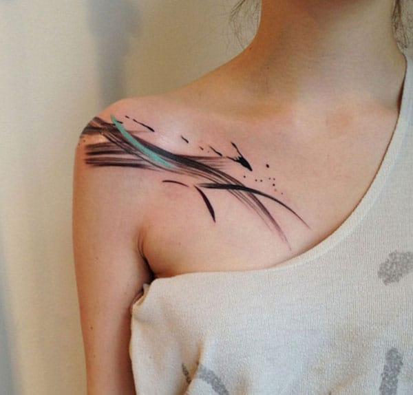 Unique black and green paint strokes watercolor tattoo on front shoulder ideas for girls