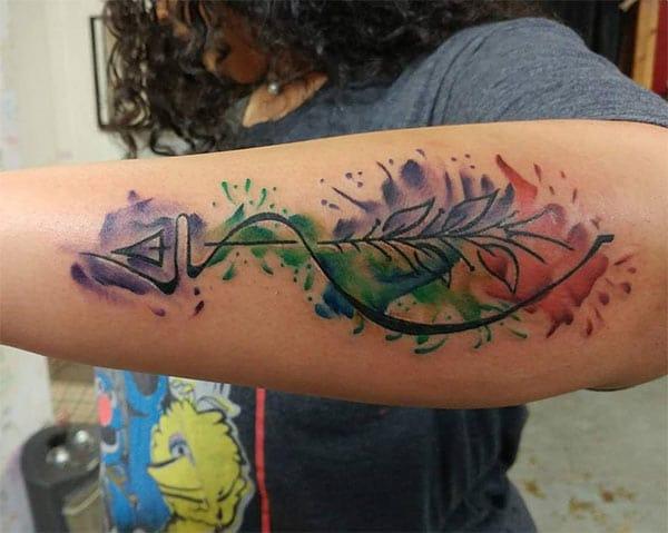Beautiful artistic arrow with leaves watercolor tattoo designs for women on hand