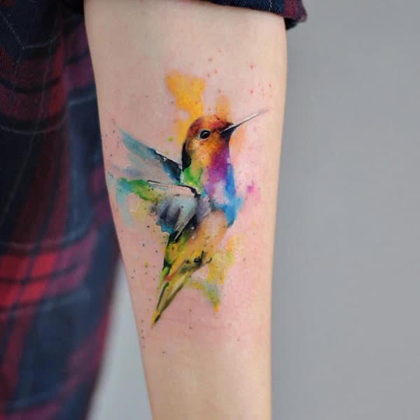 Mesmerizing Multicolored flying bird hand tattoo designs for Girls