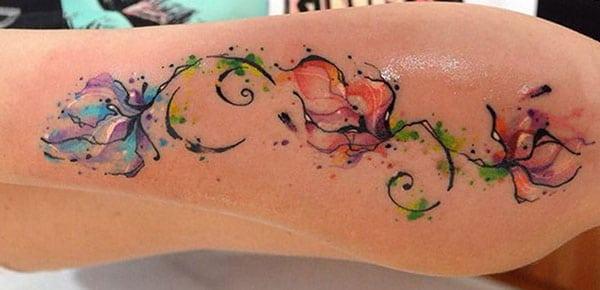 Rich colored ink splash flowers vine watercolor tattoo designs on hand for Girls