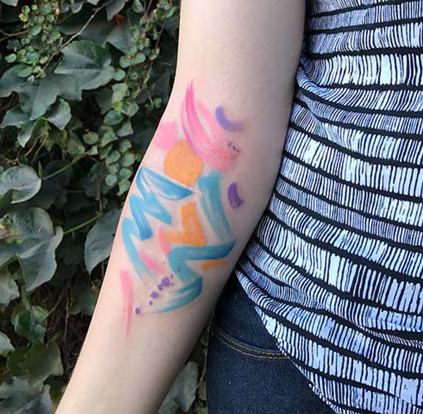 Random paint strokes of blue purple orange pink watercolor tattoo designs on hand for Girls