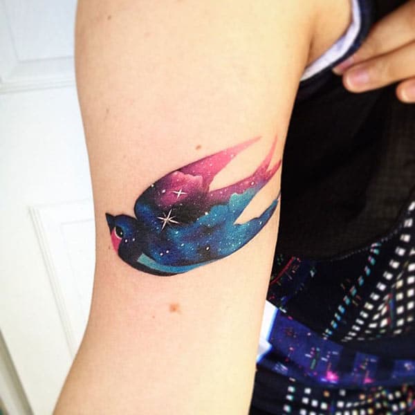 Striking Galaxy bird watercolor hand tattoo ideas for Ladies