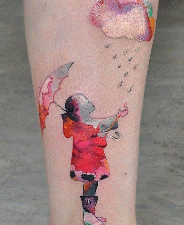 Adorable Girl enjoying the rain watercolor ink tattoo ideas on legs for Ladies