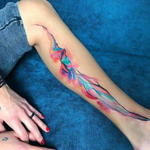 Creative mind blowing ink spilling watercolor leg tattoo designs for Ladies