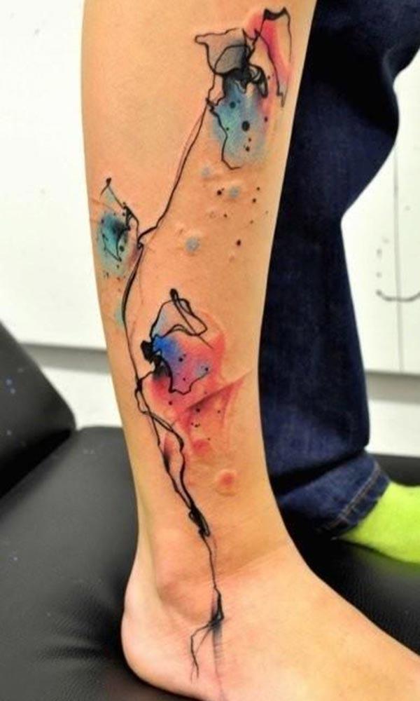 Bright Inks spillage like watercolor leg tattoo designs for modish Girls