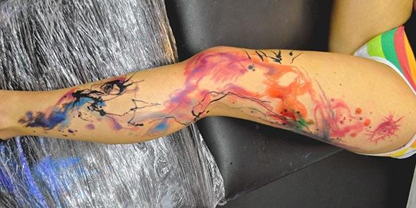 Random ink splash watercolor tattoo designs on legs for Ladies