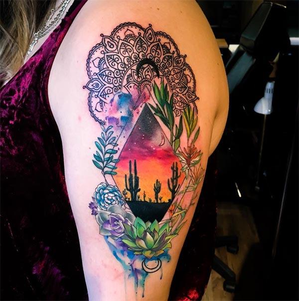 Awesome shoulder watercolor tattoo of flowers surrounding desert night in rhombus for Women