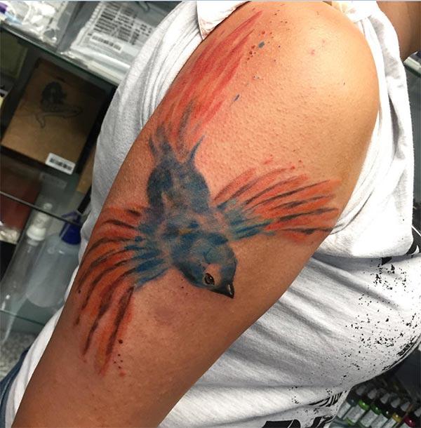 Pretty blue orange flying bird watercolor shoulder tattoo ideas for women
