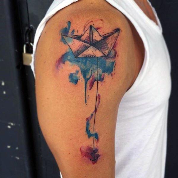 Simple and creative anchored paper boat water color ink shoulder tattoo idea