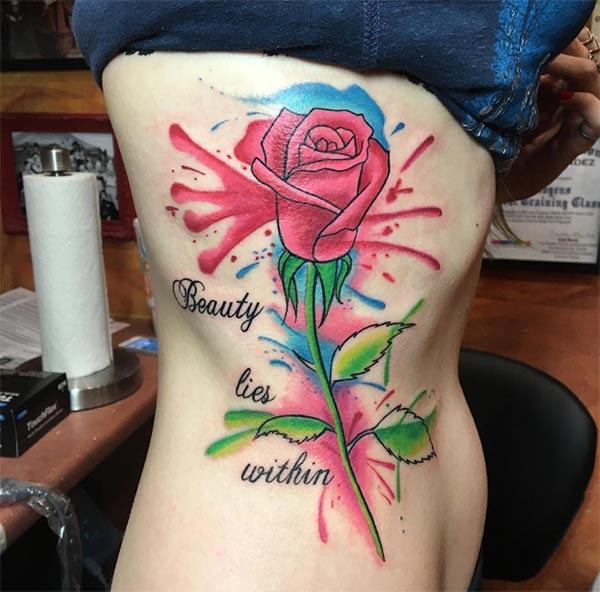 Watercolor side tattoo of huge rose and beauty lies within wordings for Girls