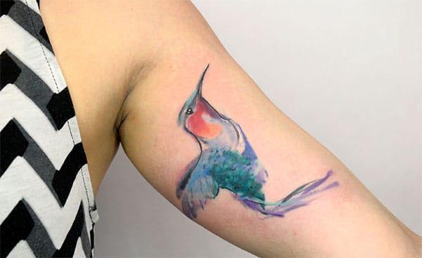 Elegant green orange Bird watercolor arm tattoo ideas for Bird loving women