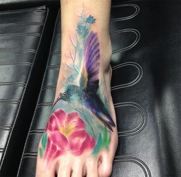 Mesmerizing hummingbird on flower watercolor leg tattoo designs for Females