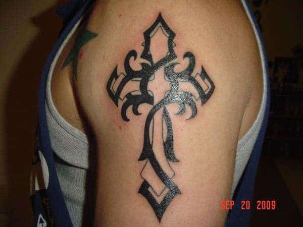 Broad black vine cross tribal tattoo ideas on shoulder for Men