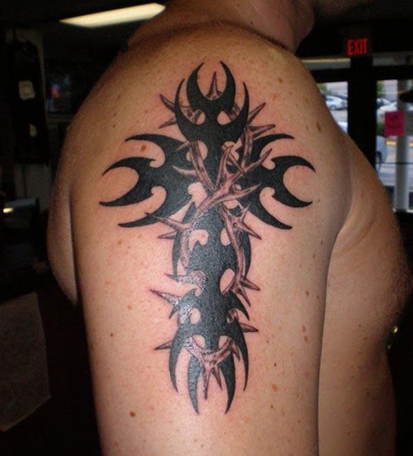Broad intense black tribal cross tattoo designs on arm for Men