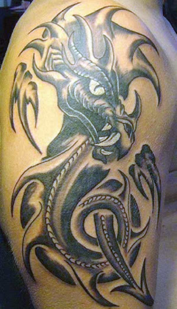Striking black tribal dragon tattoo designs on shoulder for Guys