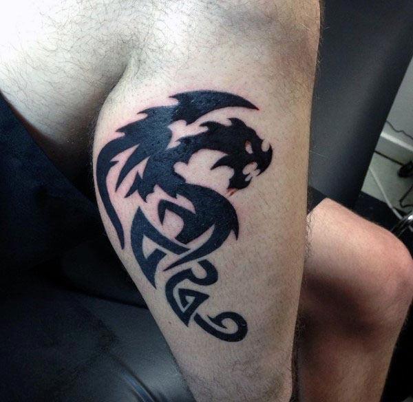 Smashing solid black Celtic dragon tattoo designs on arm for boys and men
