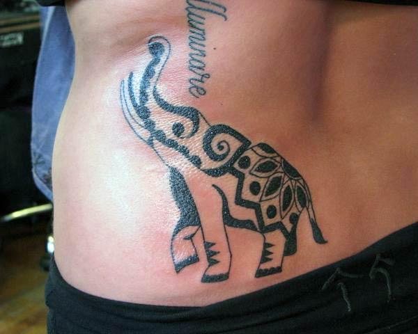 Beautiful elephant with trunk up tribal tattoo ideas on lower back for active women