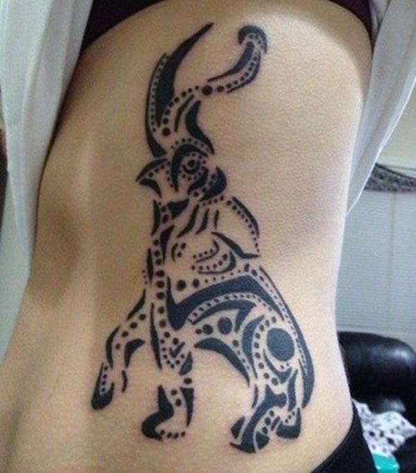 Enchanting raised trunk tribal elephant tattoo ideas for Women on side